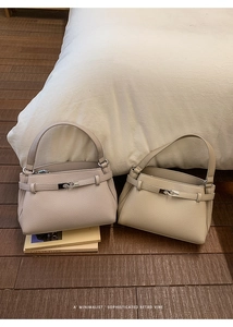 Detailed view of lychee grain leather handbags in beige and khaki with metal buckles