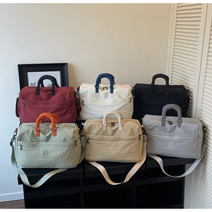 Close-up of multifunctional travel duffel bags in six colors with brand embroidery detail