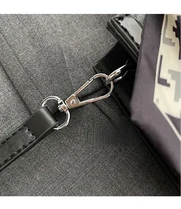 Detail of glossy black stone pattern leather bag with silver metal hardware and scarf