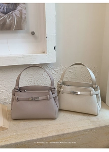Close-up of pebble leather texture and belt buckle detail on minimalist Kelly style bags