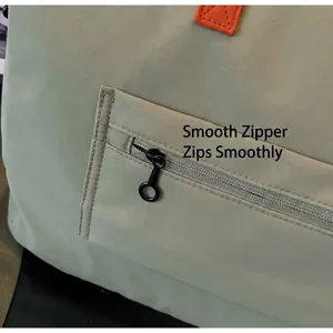 Close-up of smooth zipper with black ring pull on ripstop nylon travel bag