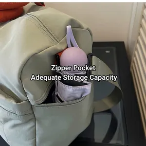 Detail view of the light green travel bag side zipper pocket with a purple umbrella