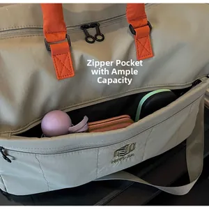 Detail view of the green travel bag's front zipper pocket showing spacious storage capacity