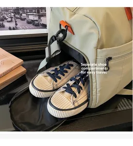 Detail of a green travel bag featuring a separate bottom compartment for shoes