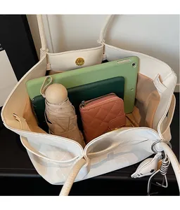 Top view of spacious cream tote bag interior with magnetic closure and daily essentials