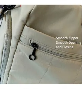 Detail view of khaki ripstop nylon fabric and smooth black ring zipper puller