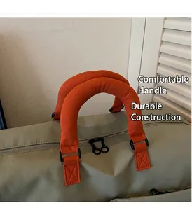 Detail of durable olive green travel bag with reinforced orange padded handles and metal hardware