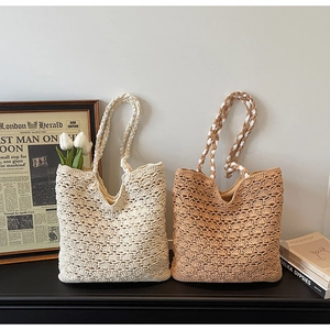 Detailed view of hand-woven crochet patterns on beige and coffee tote shoulder bags