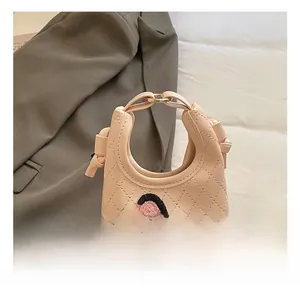 Pink mini crossbody bag featuring diamond quilting and cute cartoon pony patchwork