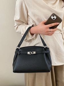 Classic black lychee grain leather handbag with silver ring closure shown on model