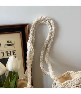 Detail of hand-woven cotton shoulder strap and hollow knit texture on a beige tote bag