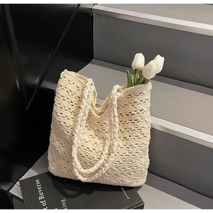 Detailed close-up of ivory crochet weave texture on a large capacity summer tote bag