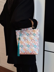 Chinese style embroidered handbag with bamboo handle and blue tassel detail