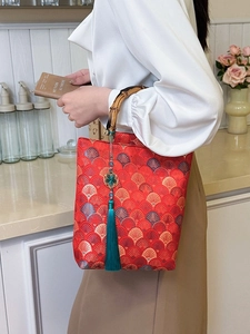 Red Chinese style embroidery handbag with natural bamboo handle and silk tassel detail