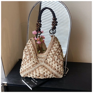 Dettaglio della borsa tote intrecciata con manico vintage in perline di legno scuro