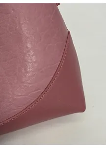Detailed close-up of textured mauve leather stitching and high-quality fabric finish