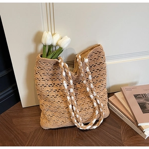 Close-up of hollow crochet tote bag featuring natural texture and woven strap detail