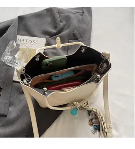 Interior view of off-white bucket bag showing spacious compartments for essentials