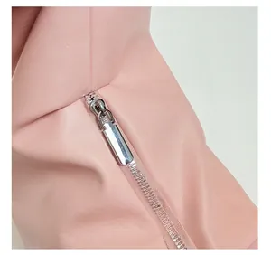 Detailed close-up of premium silver metal zipper on pink leather shoulder bag
