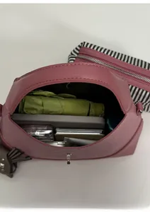 Top view of pink leather handbag interior showing large capacity for daily items