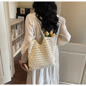 Detail of off-white hollow crochet tote bag with intricate floral woven patterns