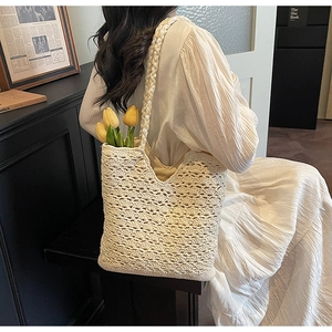 Detail of hollow woven shoulder bag texture with interior lining and tulip decoration