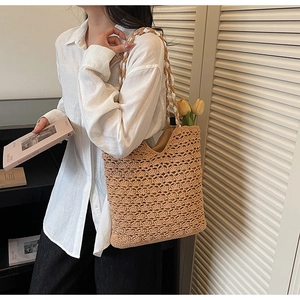 Detail of hand-woven crochet tote bag with hollow fan pattern and thick rope handle