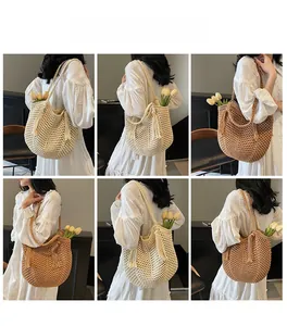 Detail view of handmade hollow crochet shoulder bag with long tassels in two colors