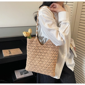 Detail of hand-woven hollow knit pattern on beige summer tote bag for women