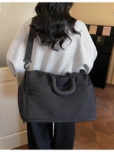 Large capacity black travel bag with adjustable strap for sports and gym use