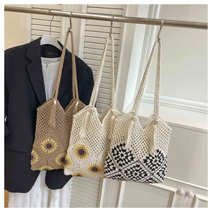 Detail of crochet sunflower tote bags with intricate hollow mesh and fringe tassels