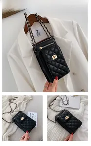 Close-up of black quilted leather mini bag with gold chain strap and twist-lock detail