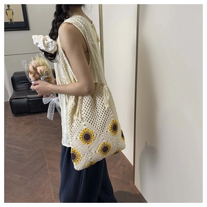 Detail of hand-woven sunflower tote bag showing crochet texture and fringe accents