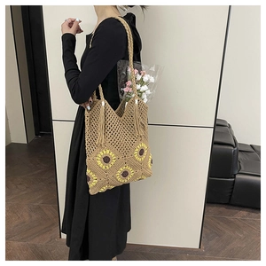 Detailed crochet texture of sunflower tote bag with tassel and woven straps