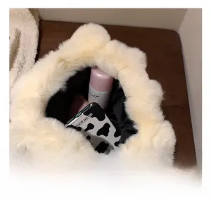 Internal view of cream faux fur tote bag showing phone case and skincare items inside