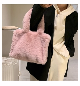 Close-up of fluffy pink faux fur tote bag showing soft texture and spacious interior