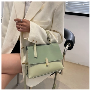 Détail du sac à bandoulière vert clair avec boucle dorée et bandoulière réglable