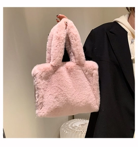 Close-up of soft pink faux fur tote bag showing the fluffy texture and stylish handle