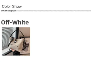 Detailed view of beige canvas tote bag with black leather handle and RESTAIN lettering