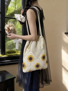 Handmade crochet sunflower tote bag in cream white with fringe detail and dual straps