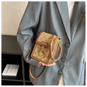 Detail of the monogram canvas mini crossbody bag with leather trim and gold hardware