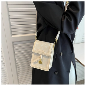 Detail of crossbody phone bag with monogram pattern and gold metal logo branding