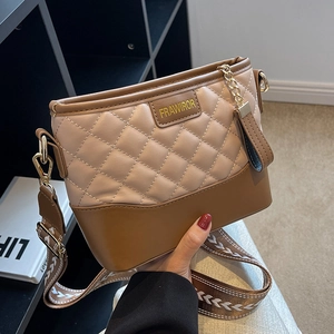 Brown and beige quilted crossbody bag with stylish wide woven strap and metal hardware