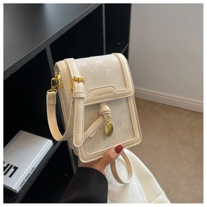 Detail of beige monogram canvas flap bag with gold hardware and leather strap