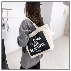 Rear view of a minimalist canvas tote bag with black graphic print for daily commuting