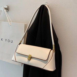 Chic beige French baguette shoulder bag with brown edges and golden push lock