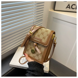 Detail of monogram canvas crossbody bag with knot decor and Luomeinisha logo