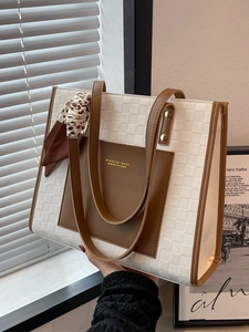 White checkered tote bag with brown leather details and leopard scarf accessory