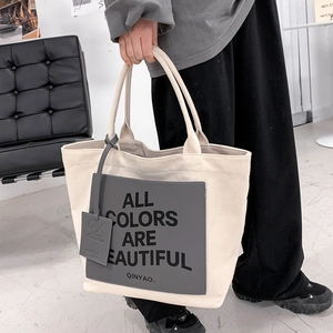 Chic beige canvas tote bag with letter print and handle for daily school or office commuting