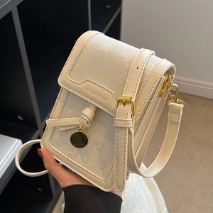 Women's beige monogram canvas crossbody bag with cream leather trim and gold hardware